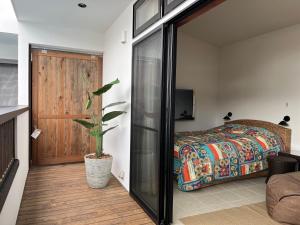 a bedroom with a bed and a sliding glass door at Onomichi Villa Ayah in Onomichi +28 photos