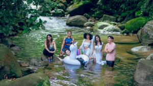 a group of women standing in the water with a swan float at Villa Sapphire by Blue Robin - Private Taiping Villa 20pax River & Waterfall in Taiping