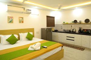 a bedroom with a large bed and a kitchen at Aeroview Homestay Near Chennai Airport and Rela Hospital in Chennai