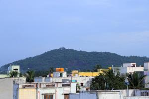 a group of buildings with a mountain in the background at Aeroview Homestay Near Chennai Airport and Rela Hospital in Chennai