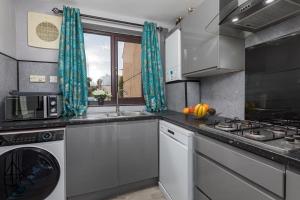 a kitchen with a sink and a stove at House -Sleeps 8 parking suitable for contractors in Ecclesfield