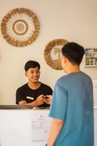 a man standing at a counter talking to a woman at Gypsy Lust Ubud in Ubud +55 photos