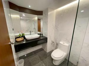 a bathroom with a white toilet and a sink at AMIS By Sima Thani in Ban Lak Roi +24 photos