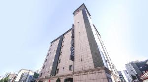 a tall building with a sign on the side of it at Hotel Circle Yonghyeon in Incheon