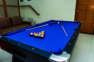 a blue pool table with balls in a room at Villa Sapphire by Blue Robin - Private Taiping Villa 20pax River & Waterfall in Taiping