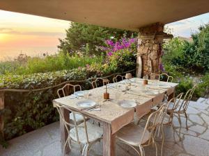 a table set up for a meal on a patio at Villa Oleandro in Costa Paradiso