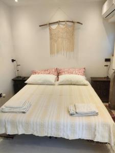 a bedroom with a large bed with two towels on it at La petite suite in Calenzano +6 photos