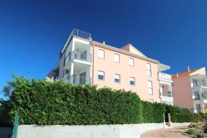 un condominio con una siepe di fronte di Apartment Luigia a Novigrad Istria