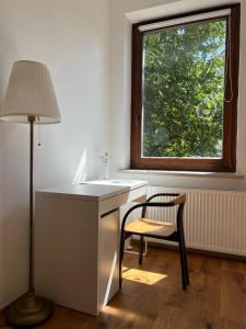 a desk and a chair in a room with a window at Prázdninový dům Šternberk in Šternberk +39 photos