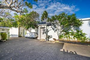 a car parked in the driveway of a house at Villa Waterlily A Sanur in Sanur