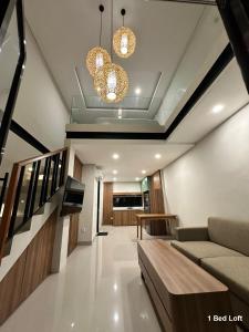a living room with a couch and a chandelier at Matra Apartment in Canggu +10 photos