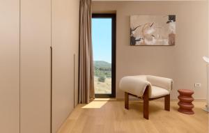 a living room with a chair and a window at Lovely Home In Primosten With Private Swimming Pool, Can Be Inside Or Outside in Šaričevi