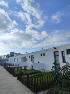 a row of white buildings with a wooden fence at SAFI VACANCES in Safi