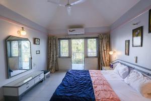 a bedroom with a large bed and a window at Marine Villa - Valley View l Swimming pool l AC in Panchgani +65 photos