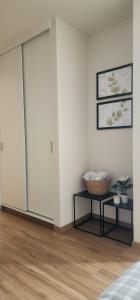 a white room with a sliding door and a table at Depa UMBRA, one block from Rebagliati Hospital in Lima