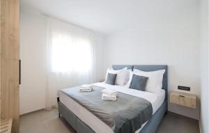 a bedroom with a large bed with two towels on it at Gorgeous Apartment In Privlaka With House Sea View in Glavan