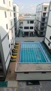 a swimming pool in the middle of two buildings at Haven 254 New Rise Gardens in Nairobi