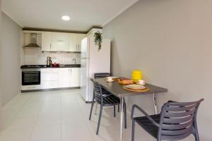 a kitchen with a table and chairs and a refrigerator at Sea View Flat in Kaleici Old Town Near Sea Park in Antalya