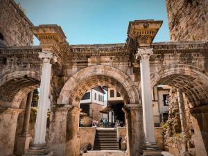 an archway in a building with people walking through it at Sea View Flat in Kaleici Old Town Near Sea Park in Antalya
