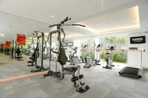 a gym with several tread machines in a room at HARRIS Hotel Kuta Galleria - Bali in Kuta