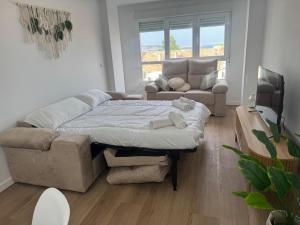 a living room with a bed and a couch at Mar de Ría 2 in Ribeira