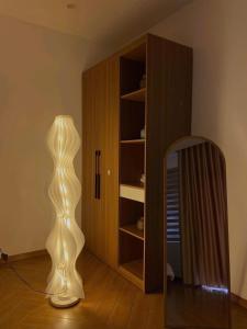 a room with a mirror and a lamp and a closet at Kimi Homestay Hue in Thôn Trường Giang