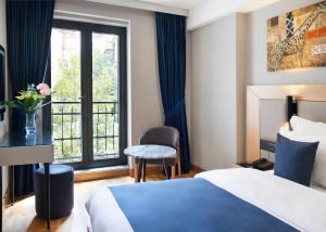 a hotel room with a bed and a window at Pera Star Hotel in Istanbul