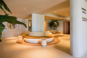 a room with two beds in a building with lights at Carlton Beach in Scheveningen