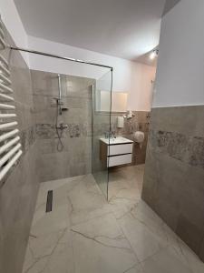 a bathroom with a shower and a sink at Kameralny Hotel TM in Radom