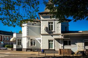 a white building with a clock tower on top of it at Hotel Adler & Eventlocation GmbH in Itzehoe