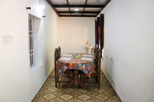 a dining room with a table and chairs in a room at The Aurora Coorg in Madikeri