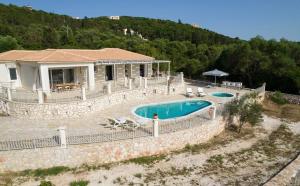 a villa with a swimming pool and a house at Ionian Mansion in Antipata