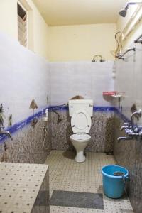 a bathroom with a toilet and a bath tub at The Aurora Coorg in Madikeri