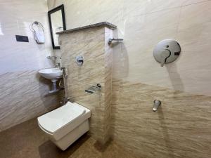 a bathroom with a toilet and a sink at RK Homes Service Apartments in Sancoale +23 photos