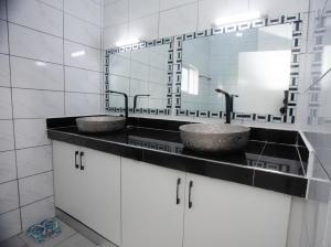 a bathroom with two sinks and a mirror at Nyali one bedroom Villa- Subree Luxury in Mombasa +13 photos