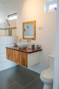 a bathroom with a sink and a toilet at Villa Charlotte in Port Mathurin +37 photos