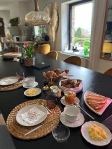 a black table with plates of food on it at Songe de Clarté in Plouigneau