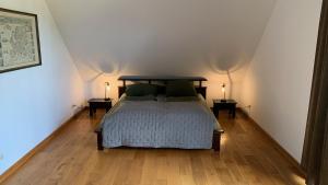 a bedroom with a bed and two lamps on two tables at Apartments Mester in Xanten
