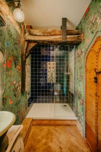 a bathroom with a shower with a glass door at Salmestone Grange in Margate