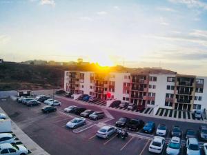 a parking lot with cars parked in front of buildings at Estrella de maryam in Tijuana