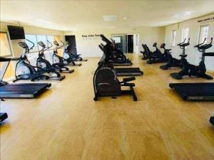 a gym with a row of treadmills and exercise bikes at Estrella de maryam in Tijuana