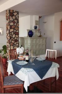 a dining room table with a bottle of wine on it at Albergo Miramonti in Lavarone