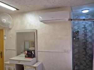 a bathroom with a mirror and a air conditioner at hostel ـ Karak dream in Kerak +147 photos