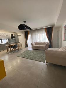 a large living room with a couch and a table at Nicolle Luxury Promenada in Craiova
