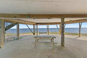 a picnic table in front of the ocean at Rustic Retreat in Ocean Springs