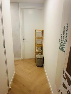 a hallway with white walls and wooden floors at B&B s12 in Doetinchem