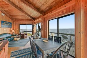 a dining room with a table and a view of the ocean at Rustic Retreat in Ocean Springs +37 photos