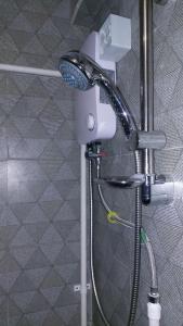 a shower in a bathroom with a blow dryer at Sigatoka Town Home in Coral Coast in Singatoka