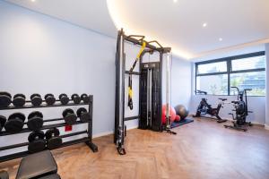 a gym with a bunch of equipment in a room at 1007 Zeeland - Top Floor Stylish Studio Near CTICC in Cape Town