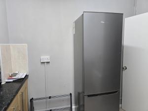 a stainless steel refrigerator in a kitchen at Central Luxe Stay - 4 mins to Aldgate East Station in London